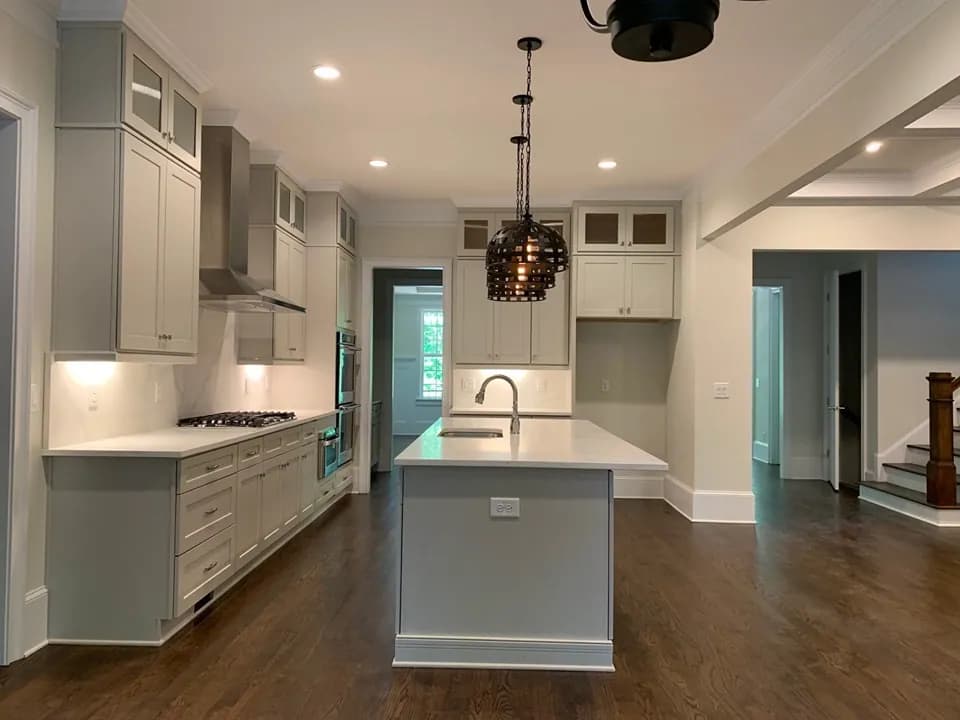 Greige kitchen island looking toward the hallway